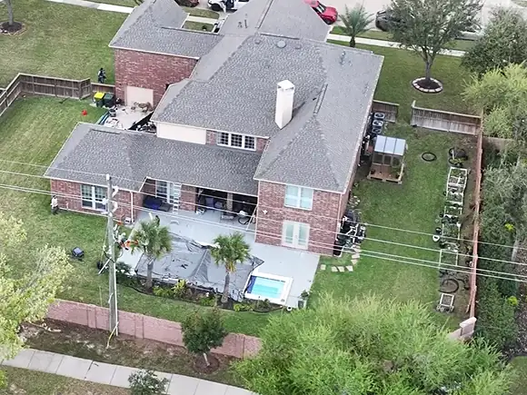 The same two-story brick home with its new roof finished