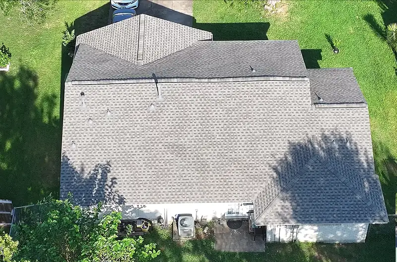 Single-story home in the Houston area from above with a completed light gray shingle roof
