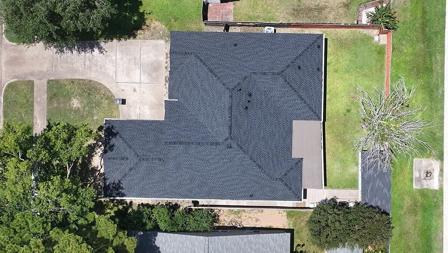 Brick home in the Houston area from above with a completed dark shingle roof by 3 S Roofing