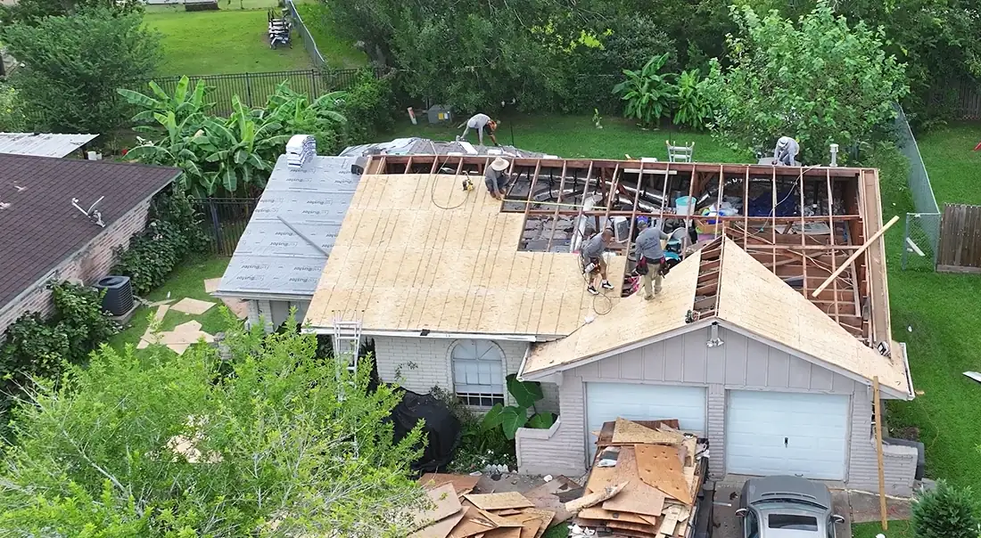 3 S Roofing crew replacing damaged roof decking on one section of a home in the Houston area