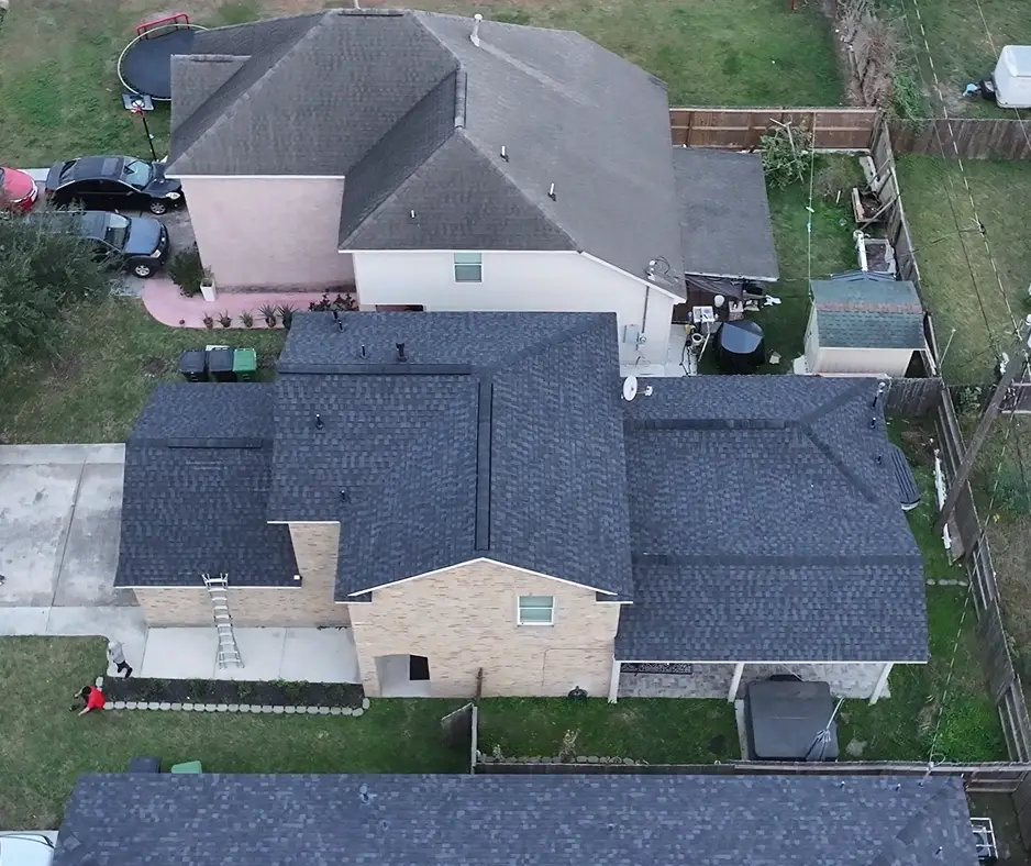 The same two-story home with its new roof finished