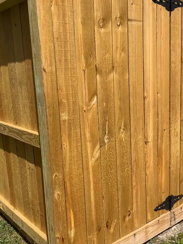 New wood fence gate with black hinges